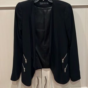 Black open jacket. Has some shoulder padding. It dresses up a pair of jeans.